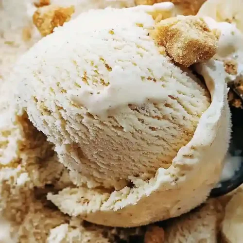 A scoop of banana pudding ice cream in a cone