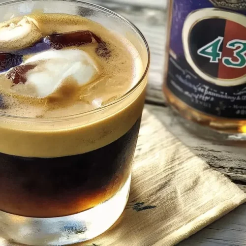 A freshly made carajillo cocktail served over ice with espresso and Licor 43